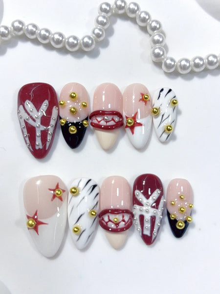 Ivory Illusion Press-On Nägel Mandelform mittellang, Rot, Schwarz und Weiß mit grafischen Motiven, Sternen sowie goldenen und silbernen Akzenten